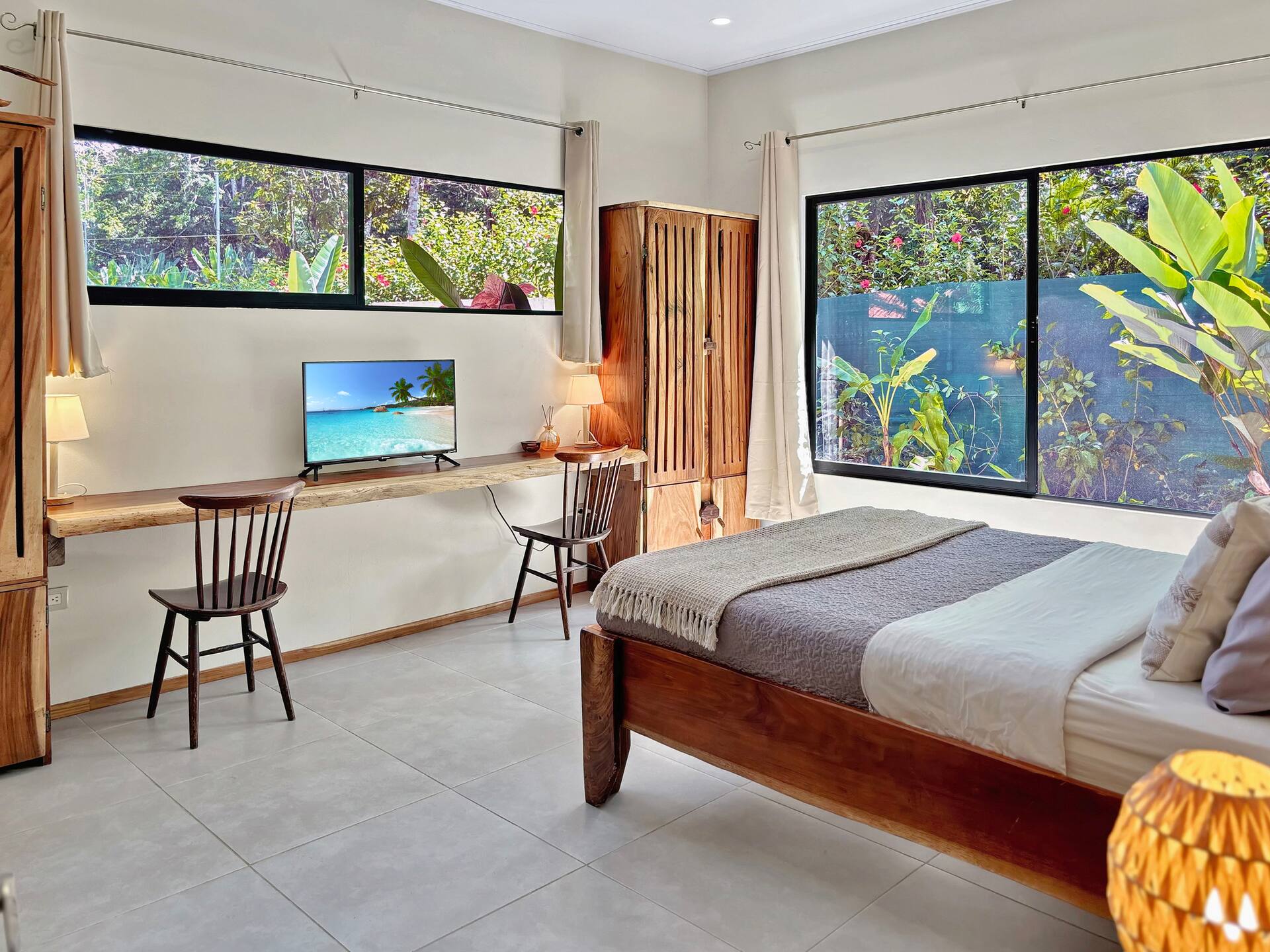 Serene bedroom with natural light and peaceful jungle views