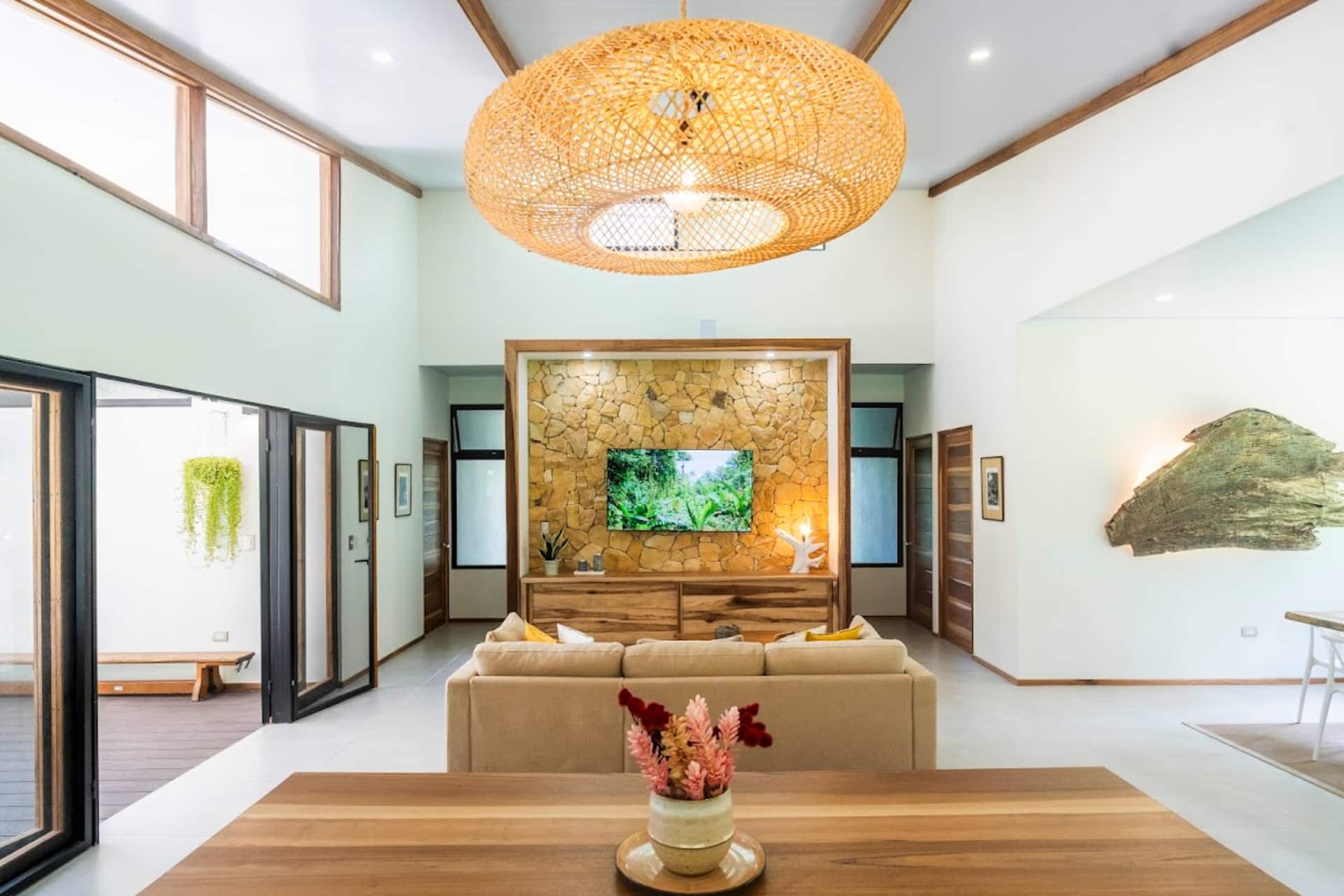 Beautiful open-concept living room at Casa River Koa with stylish rattan lighting and comfortable seating